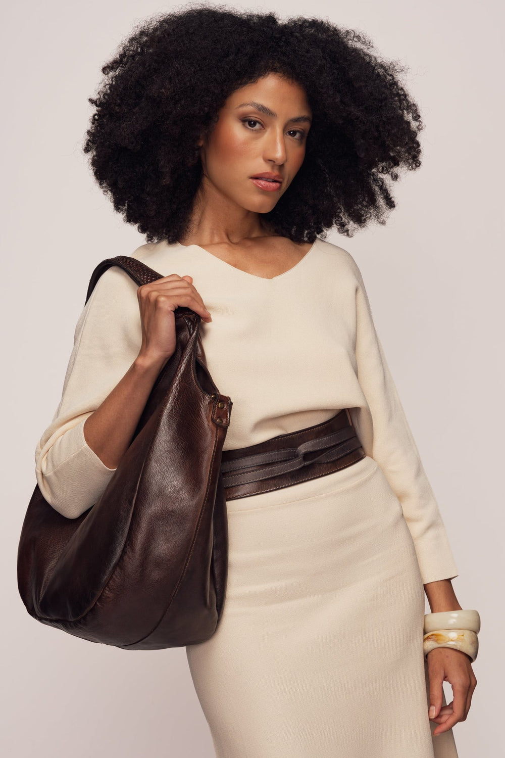 Vegetable Tanned Leather Obi Belt - Chocolate Brown MODEL HOLDING CARRYALL AND WEARING MATCHING OBI BELT | LUSHER