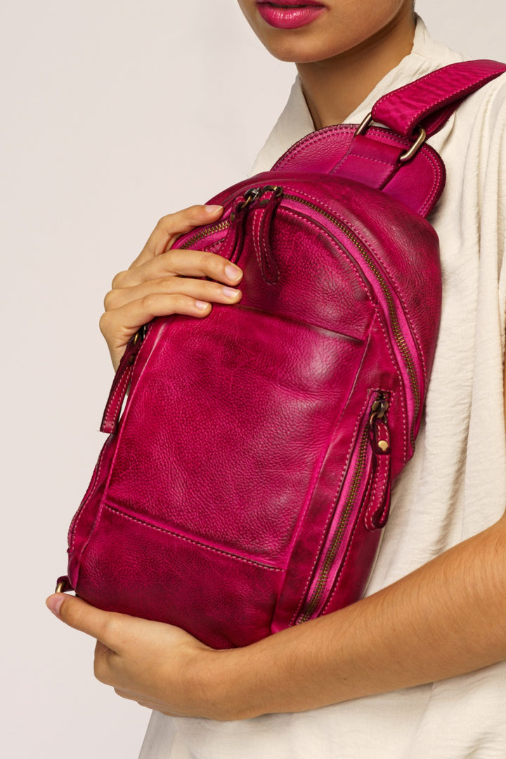 LUSHER movement sling bag in fuchsia pink Italian leather worn crossbody by a women