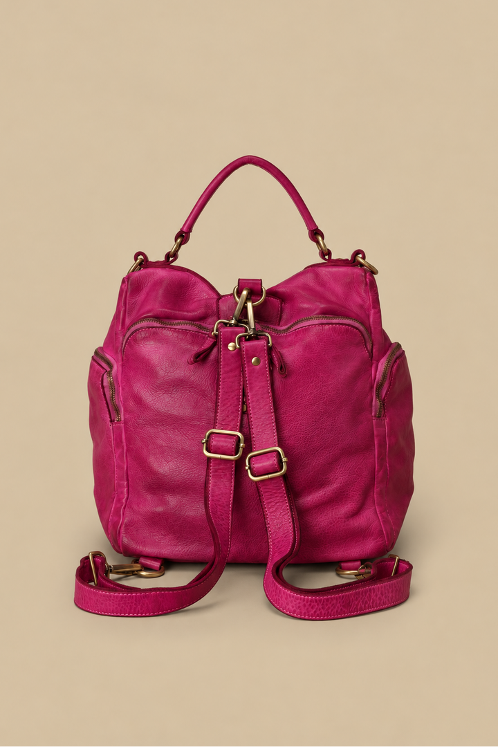 The Original Quest Backpack Purse in Fuchsia showing the back of the bag and two removable, adjustable leather straps