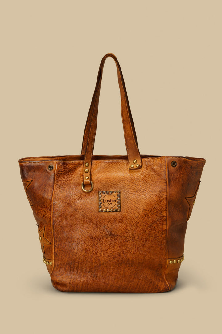 LUSHER STAR TOTE IN COGNAC, LARGE LEATHER TOTE WITH STARS AND STUDS, STUDDED LEATHER TOTE BAG, STAR PURSE, PURSE WITH STARS, FREE PEOPLE TOTE BAG WITH STARS, 